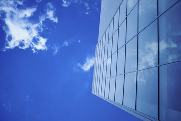 Modern glass building on blue sky office exterior