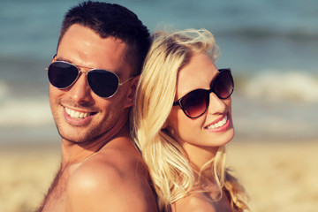 Poster - happy couple in swimwear sitting on summer beach