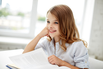 Poster - happy student girl reading book at school