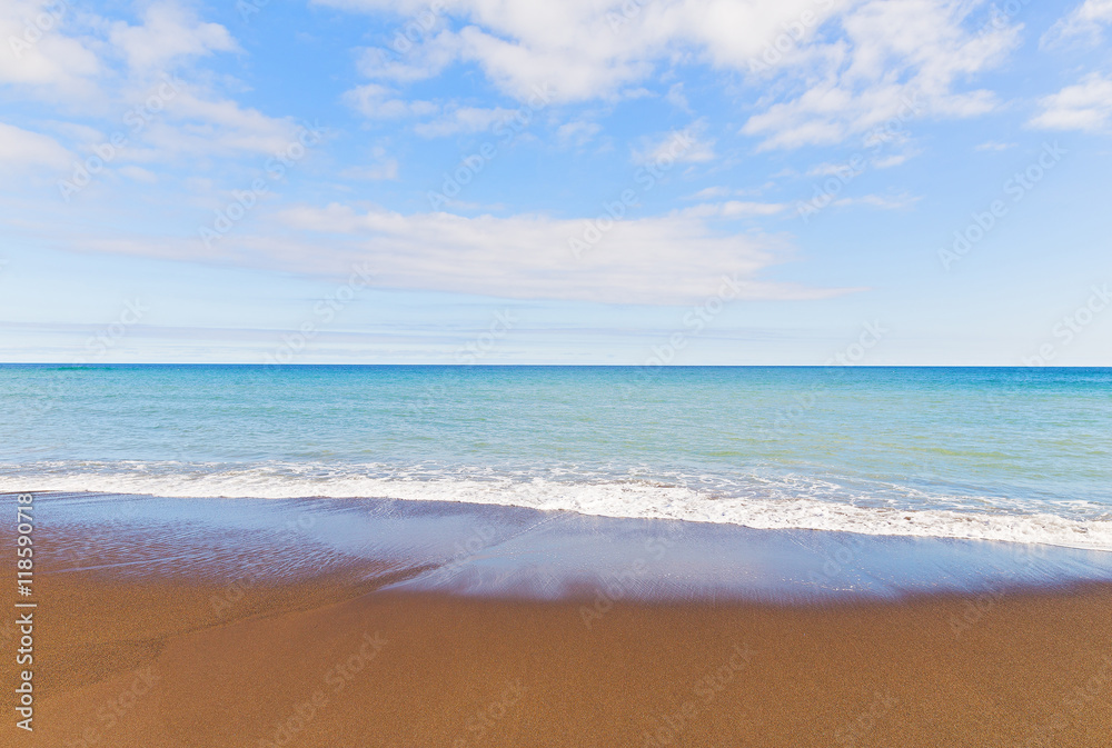 Ocean wave tracery on an empty sandy beach of Sao Miguel Island ...
