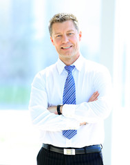 Sticker - Portrait of happy smiling businessman in a modern office