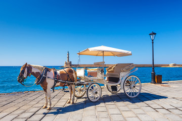 Wall Mural - Horse carriage for transporting tourists in old port of Chania on Crete, Greece