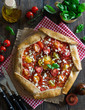 © irinagoleva - Whole wheat galette with tomatoes, feta cheese and fresh basil, overhead shot