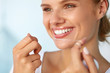 © puhhha - Dental Hygiene. Beautiful Woman Flossing Healthy White Teeth. High Resolution Image