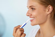 © puhhha - Teeth Whitening. Beautiful Woman Using Teeth Whitening Pen. High Resolution Image