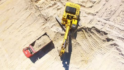 Wall Mural - Camera flight over a working excavator in the mine. Industrial footage on mining theme. Heavy industry in Central Europe.