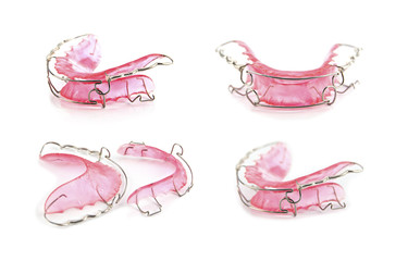 close up pink dental braces or retainer isolated on white backgr