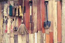 Agricultural Tools Hang On Wooden Wall In Farm - Rural Vintage Style