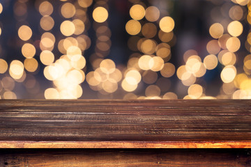 Wall Mural - top of wood table with christmas abstract background light bokeh from xmas tree at night party in wi
