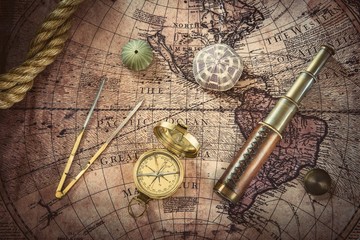 Fototapete - Old compass and telescope on vintage map. Retro style.