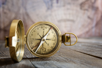 Fototapete - Old compass on the vintage map background. Retro style.