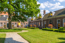 Green Courtyard Surrounded By Old Almshouses In Hofje Van Staats In City Of Haarlem, Holland, Netherlands