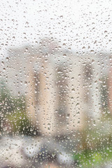 Wall Mural - view of raindrops on window of apartment house