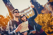 © Mediteraneo - Happy tourists couple holding map in the autumn park