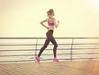 © Africa Studio - Young woman running on pier