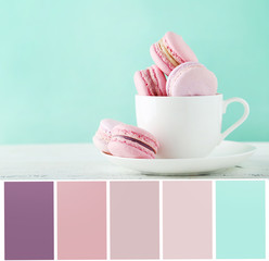 Sticker - Color palette with french macarons in cup on white wooden backgr