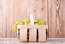 White Grape Harvest In A Wicker Basket On The Table