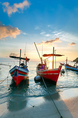 Wall Mural - Sunset on the beach with colourful fishing boats