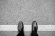 Black shoes standing on white line