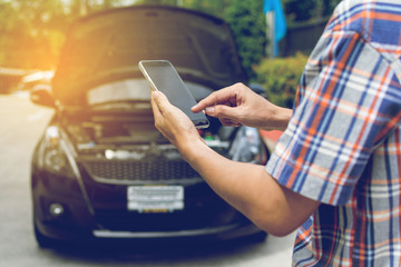 Man Phoning For Help with a broken down car