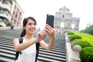 Wall Mural - Woman taking selfie by mobile phone in Macao