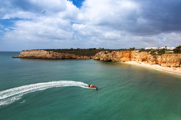Wall Mural - Speedboat at sea, view from above. Algarve, Portugal, Armacao de Pera