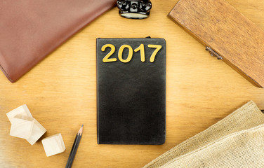 Poster - Wooden Table top with  clock,type box,notebook,leather bag and p