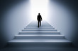© Photocreo Bednarek - Businessman climbing the stairs towards light.