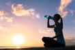 Young active woman outdoors drinking bottle of water. 