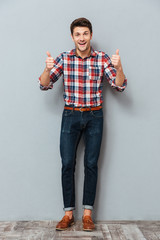 Poster - Full length portrait of a happy man showing thumbs up