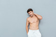 Attractive shirtless young man standing and posing