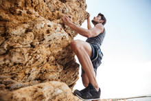 Young Man Climbing Natural Rocky Wall