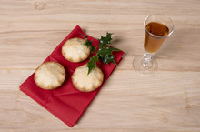Image Of Three Mince Pies On A Red Napkin With A Glass Of Sherry