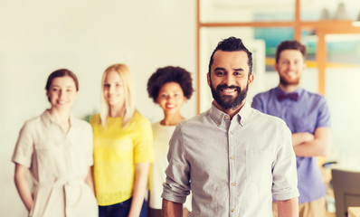 Wall Mural - happy young man over creative team in office