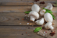Fresh Mushrooms And Garlic On Wooden Background