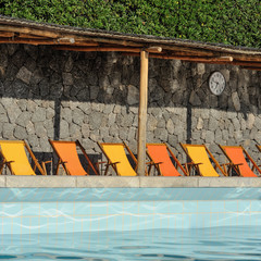 Pool with orange and yellow sunbeds