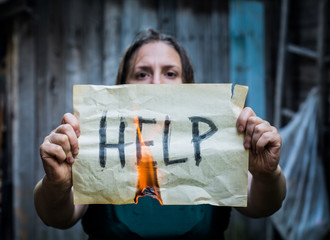 A girl holding a sheet of paper with the word 