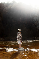 Canvas Print - beautiful woman traveler back standing on rocks in river, wearin