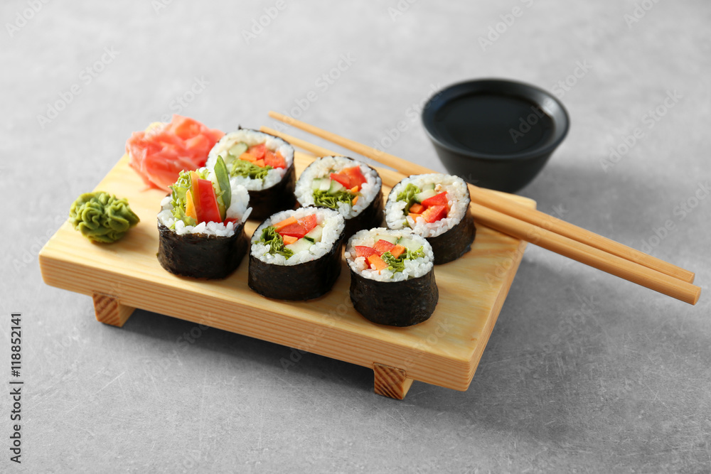 Delicious sushi rolls on table