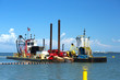 Dredging vessel and a multipurpose work boat work side by side as they excavate sand at Fort Myers Beach, Florida, USA:  