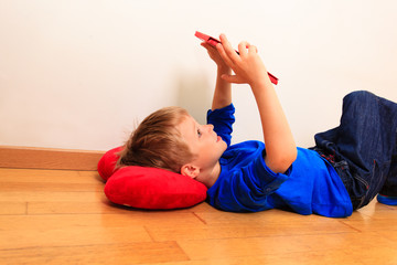 Wall Mural - little boy looking at touch pad, learning concept