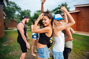 Sticker - Young cheerful happy teens dancing at the picnic area