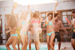 © Drobot Dean - Group of best friends having fun dancing at swimming pool