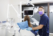 © Tyler Olson - Mid Adult Dentist By Female Patient In Clinic