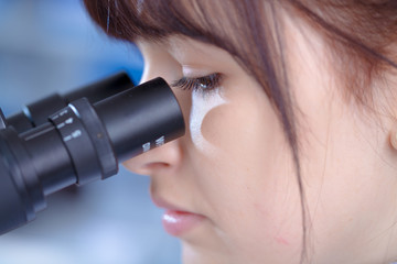 Wall Mural - Young woman technician use microscope  in laboratory