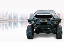 Closeup Front Of Off Road Truck With Beautiful Cityscape Background.
