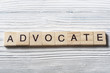 Advocate word written on wood abc block at wooden background