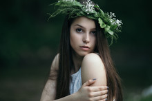Fine Art Outdoor Portrait Of Beautiful Young Woman In A White Dress Wearing Floral Wreath.