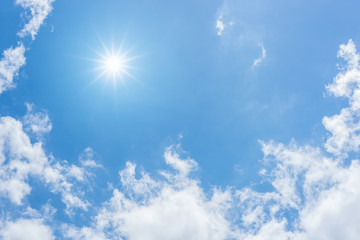 blue sky with clouds and sun reflection. looking up view