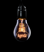 Hanging Lightbulb With Glowing Agenda Concept.